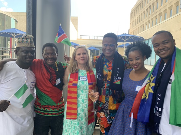 Image of Anne Converse Willkomm flanked by 5 Fellows in traditional African attire.
